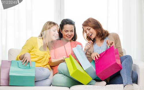 Image of smiling teenage girls with many shopping bags