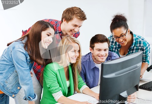 Image of students with computer studying at school