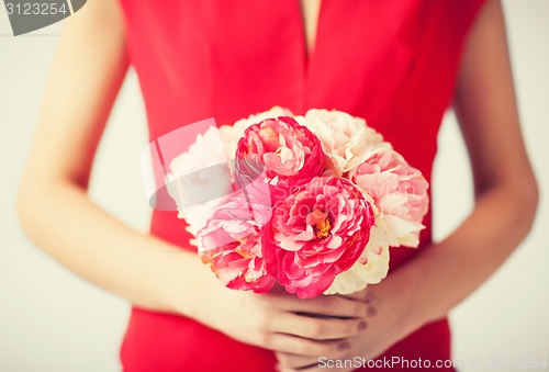 Image of woman hands with bouquet of flowers