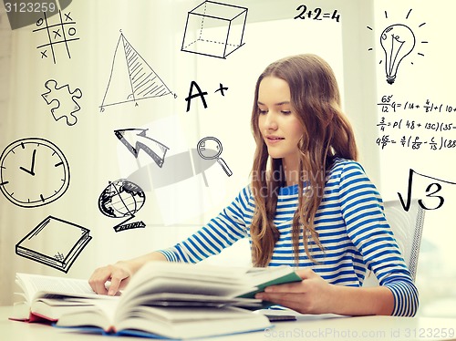 Image of smiling student girl reading books at home