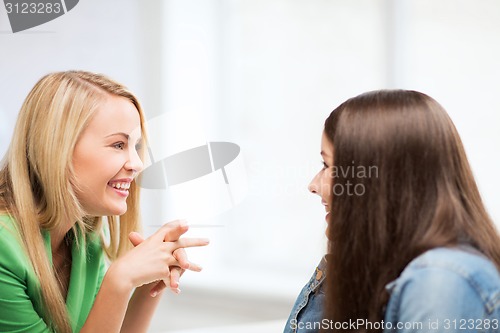 Image of student girls gossiping at school