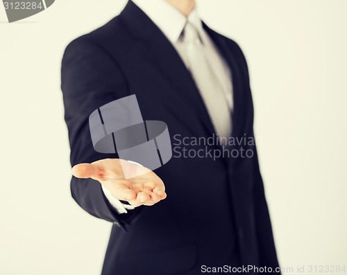 Image of mans hand showing something