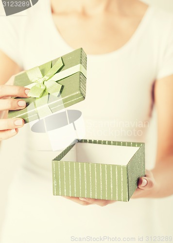 Image of woman hands with gift box