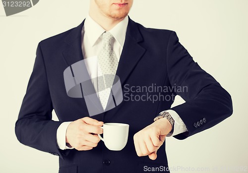 Image of man looking at wristwatch