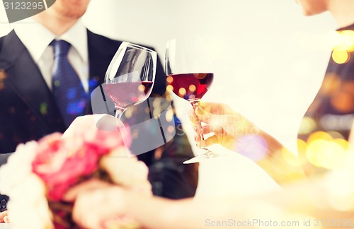 Image of engaged couple with wine glasses