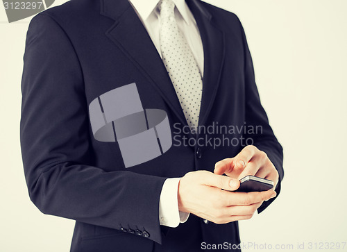 Image of man with smartphone typing something