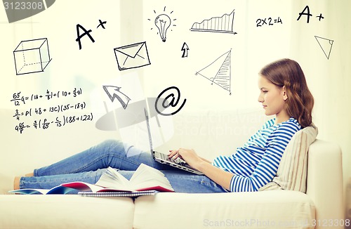 Image of busy teenage girl with laptop computer at home