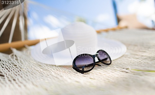 Image of picture of hammock with white hat and sunglasses