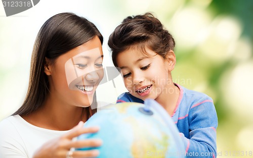 Image of happy mother and daughter with globe