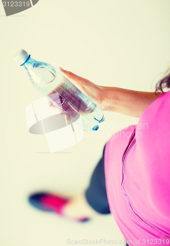 Image of sporty woman with bottle of water