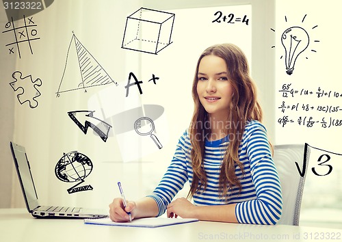 Image of smiling teenage girl laptop computer and notebook