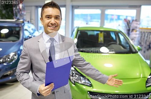 Image of happy man at auto show or car salon