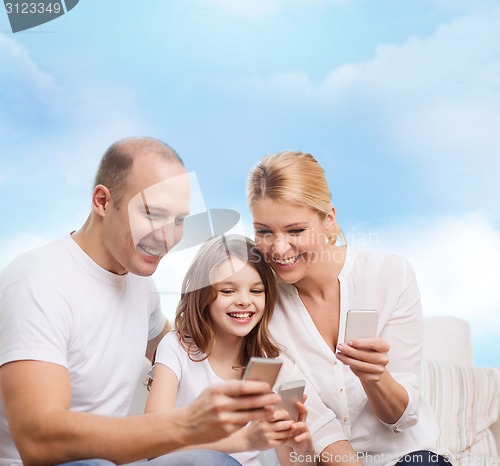 Image of happy family with smartphones