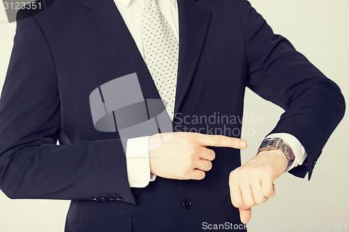 Image of man looking at wristwatch