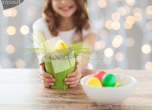 Image of close up of girl holding pot with easter grass
