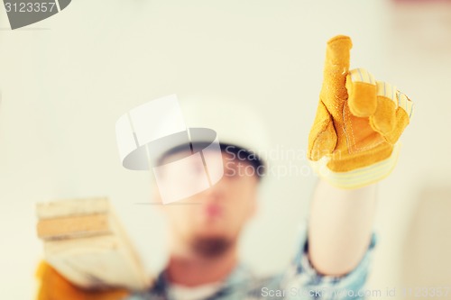 Image of close up of male in gloves carrying wooden boards