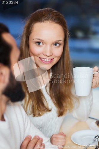 Image of happy couple meeting and drinking tea or coffee