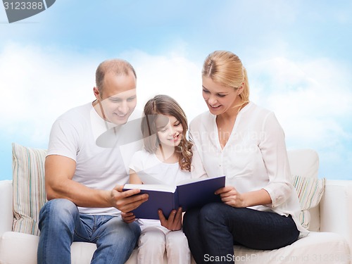 Image of happy family with book at home