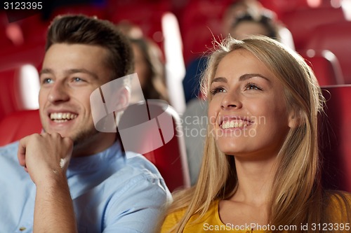 Image of happy friends watching movie in theater