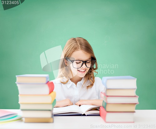 Image of happy student girl reading book at school