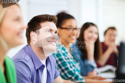 Image of students with computers studying at school