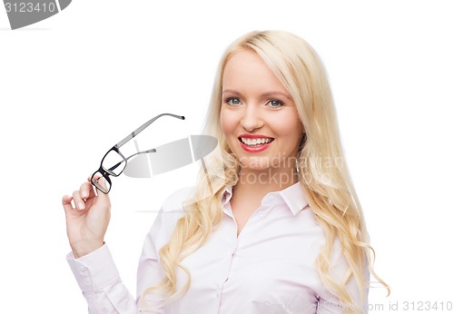 Image of smiling businesswoman or secretary in office