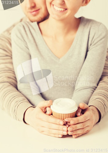 Image of woman and man with take away coffee cup