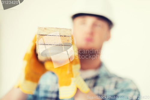 Image of close up of male in gloves carrying wooden boards