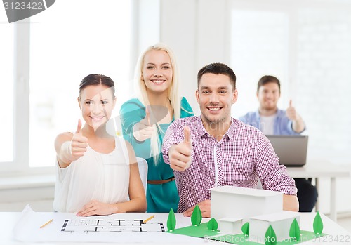 Image of smiling architects working in office