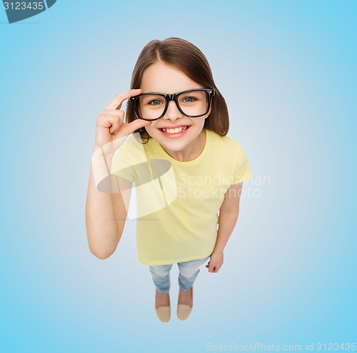 Image of smiling little girl in black eyeglasses