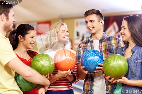 Image of happy friends in bowling club