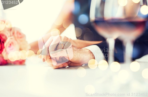 Image of engaged couple with wine glasses