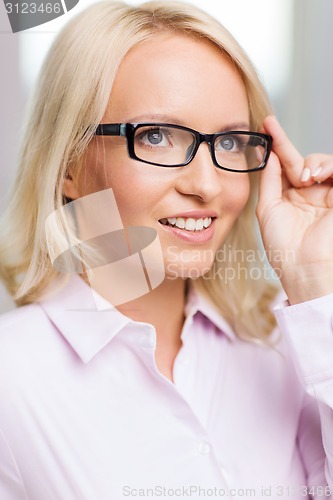 Image of smiling businesswoman or secretary in office