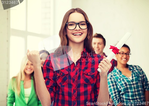 Image of smiling female student in eyeglasses with diploma