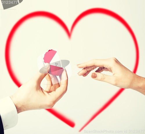 Image of couple with wedding ring and gift box