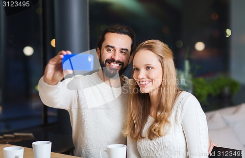 Image of happy couple with tablet pc and coffee at cafe