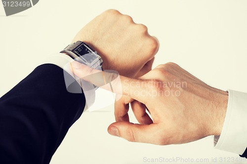 Image of man looking at wristwatch