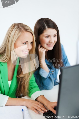 Image of students looking at tablet pc at school