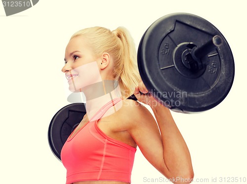 Image of smiling sporty woman exercising with barbell