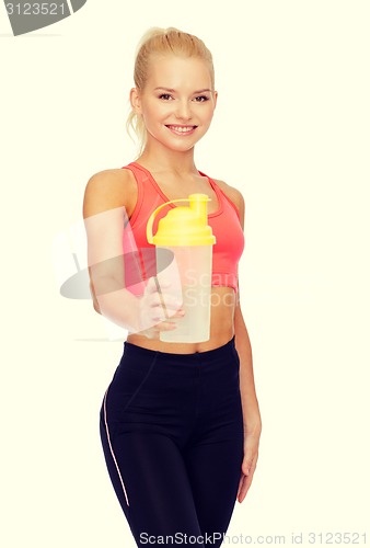 Image of smiling sporty woman with protein shake bottle