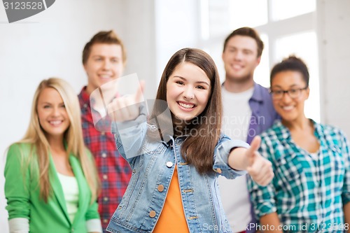 Image of students showing thumbs up at school