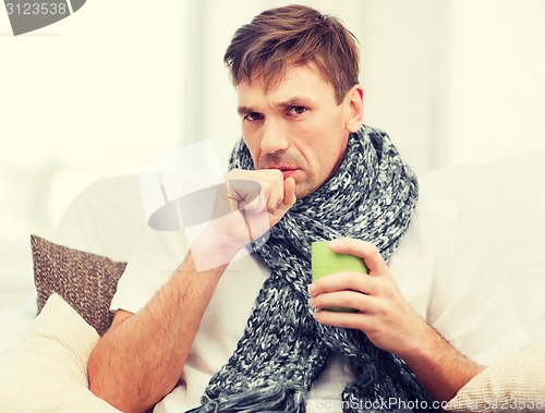 Image of ill man with flu at home
