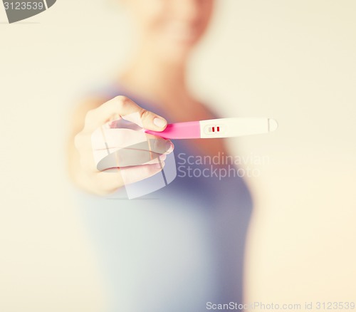 Image of woman with pregnancy test