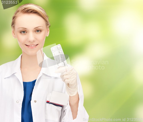 Image of happy female doctor with pills