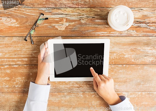Image of close up of female hands with tablet pc and coffee