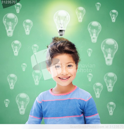 Image of smiling little school girl over light bulbs