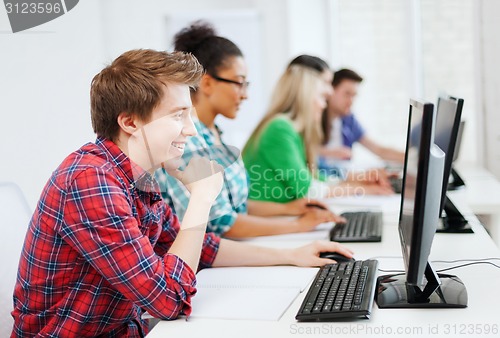 Image of student with computer studying at school