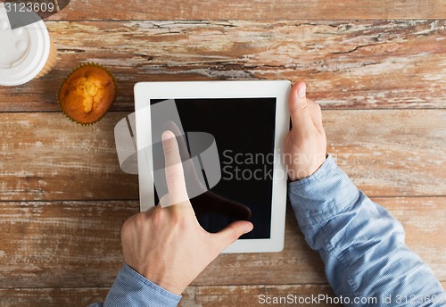 Image of close up of male hands with tablet pc and coffee