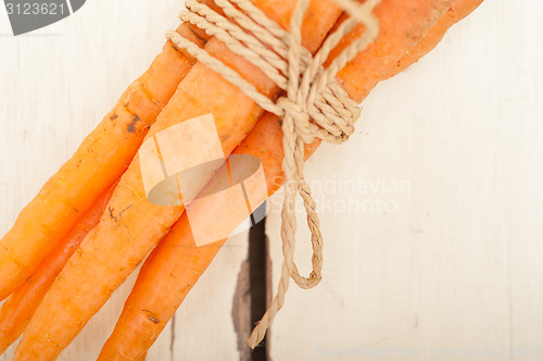 Image of baby carrots bunch tied with rope