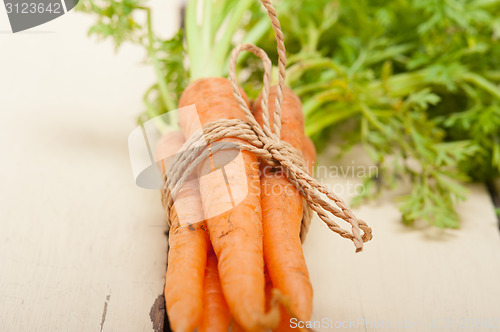 Image of baby carrots bunch tied with rope